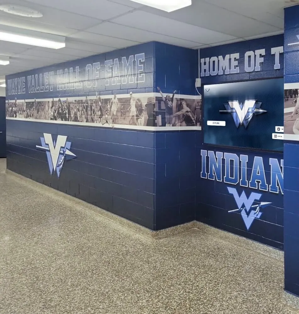 Wayne Valley hall of fame athletic hallway with mural and display board